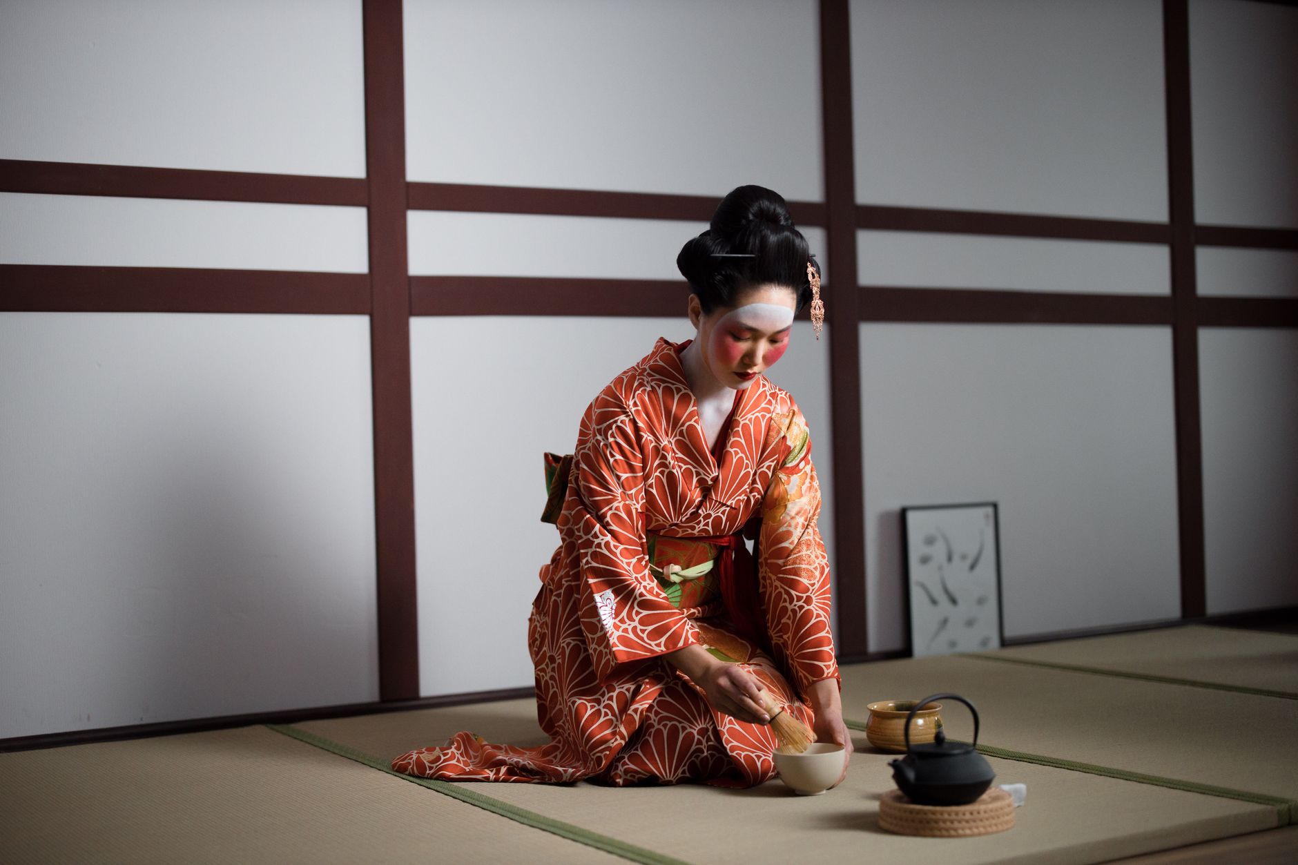 Zen courtyard with raked pebbles and maple tree